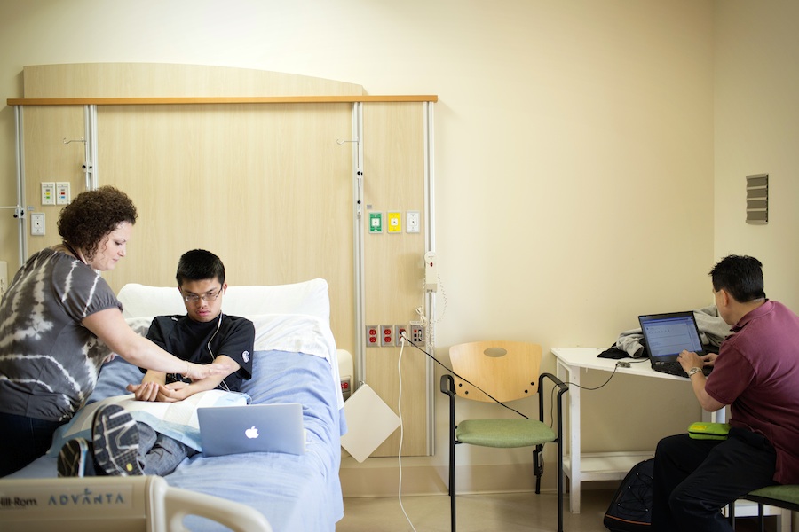 Physician assistant and clinical manager Tina Dominguez, left, administers a skin test on Steven Hom for his peanut allergy at El Camino Hospital in Mountain View, Calif. Photo by Alison Yin.