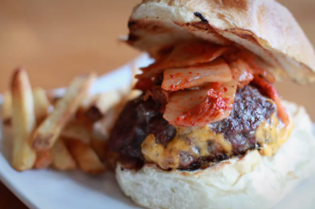 Kimchi on a burger. Still shot from Off the Menu: Asian America.